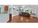 Spacious living room with hardwood floors and open layout, flowing into the kitchen and dining areas at 5771 Macaw Pl, Lakeland, FL 33809