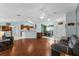 Open-concept living room with hardwood floors, ceiling fan, and ample natural light at 5771 Macaw Pl, Lakeland, FL 33809