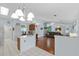 Open concept kitchen and living room with tile and wood floors and ample lighting at 5771 Macaw Pl, Lakeland, FL 33809