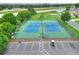 Aerial shot of the community tennis courts with parking and well-maintained green surroundings at 5771 Macaw Pl, Lakeland, FL 33809