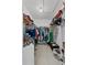 Spacious walk-in closet with hanging clothes, tile floor, and wire shelving for storage at 5771 Macaw Pl, Lakeland, FL 33809