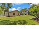 Lush backyard showcasing a playset and a screened-in pool area, complemented by a well-maintained lawn at 5819 Hollyhock Dr, Lakeland, FL 33813