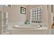 This bathroom features an elegant soaking tub with a glass block window at 5819 Hollyhock Dr, Lakeland, FL 33813