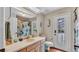 Bathroom featuring a single sink vanity and a door that leads to the backyard pool at 5819 Hollyhock Dr, Lakeland, FL 33813
