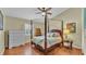 Relaxing bedroom with a four-poster bed, ample storage, and a neutral color scheme at 5819 Hollyhock Dr, Lakeland, FL 33813