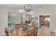 Open dining area with chandelier that seamlessly connects to the kitchen and living spaces at 5819 Hollyhock Dr, Lakeland, FL 33813