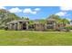 Beautiful home with lush landscaping, mature palms, and manicured lawn at 5819 Hollyhock Dr, Lakeland, FL 33813