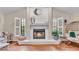 Close up of living room fireplace with white tile, hearth, and wooden mantel at 5819 Hollyhock Dr, Lakeland, FL 33813