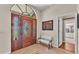 Grand foyer with beautiful front door and white bench seating at 5819 Hollyhock Dr, Lakeland, FL 33813