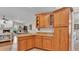 Kitchen with wooden cabinets, granite counters, and seamless flow to the living area at 5819 Hollyhock Dr, Lakeland, FL 33813