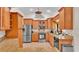 Kitchen with wood cabinetry, stainless steel refrigerator and granite countertops at 5819 Hollyhock Dr, Lakeland, FL 33813