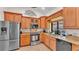 Kitchen featuring wood cabinets, granite countertops, and stainless steel appliances at 5819 Hollyhock Dr, Lakeland, FL 33813