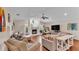 Bright living room featuring a cozy fireplace, hardwood floors, and comfortable seating at 5819 Hollyhock Dr, Lakeland, FL 33813