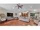 Open-concept living area with wood flooring flowing into the kitchen and dining spaces at 5819 Hollyhock Dr, Lakeland, FL 33813
