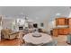Open-concept living room with fireplace, ceiling fan, and hardwood floors adjacent to the kitchen at 5819 Hollyhock Dr, Lakeland, FL 33813