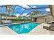 Gorgeous screened-in pool area with a sun deck and comfortable seating, perfect for relaxation at 5819 Hollyhock Dr, Lakeland, FL 33813