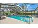 Inviting screened-in pool with a lounge area, mature landscaping, and a playset in the backyard at 5819 Hollyhock Dr, Lakeland, FL 33813