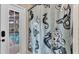Bathroom shower with sliding glass door and a fun mermaid themed shower curtain design at 5819 Hollyhock Dr, Lakeland, FL 33813