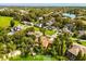 An aerial view showcases lush landscaping and serene lake views, enhancing the property's appeal at 6033 Mountain Lake Dr, Lakeland, FL 33813