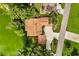 Aerial view of the house with a lakefront location, lush trees, and ample parking at 6033 Mountain Lake Dr, Lakeland, FL 33813