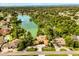 A beautiful aerial view of a community lake surrounded by lush greenery and charming homes at 6033 Mountain Lake Dr, Lakeland, FL 33813