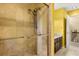 Walk in shower with a glass door and stone tiles at 6033 Mountain Lake Dr, Lakeland, FL 33813