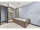 Modern bathroom features a soaking tub, step-in shower, skylight, contemporary fixtures, and tile flooring at 6033 Mountain Lake Dr, Lakeland, FL 33813