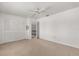 Empty bedroom with closet, carpet flooring, ceiling fan and access to hallway at 6033 Mountain Lake Dr, Lakeland, FL 33813