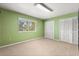 Empty bedroom with lime walls, carpet and double closets at 6033 Mountain Lake Dr, Lakeland, FL 33813