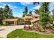 Charming home featuring a stone facade, mature landscaping, and a well-manicured lawn at 6033 Mountain Lake Dr, Lakeland, FL 33813