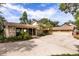 This exterior elevation features an attached three car garage, stone accents, and a screened in porch at 6033 Mountain Lake Dr, Lakeland, FL 33813