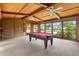 Game room with a pool table, ceiling fans, and large windows overlooking the neighborhood at 6033 Mountain Lake Dr, Lakeland, FL 33813