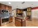 Gourmet kitchen with stainless steel appliances, island with countertop seating, and custom cabinetry with ample storage at 6033 Mountain Lake Dr, Lakeland, FL 33813
