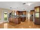 Spacious kitchen with hardwood floors, dual islands, stainless steel appliances and ample dark wood cabinetry at 6033 Mountain Lake Dr, Lakeland, FL 33813