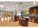 Open kitchen with hardwood floors, stainless steel appliances, dual islands, modern lighting, and eat in breakfast area at 6033 Mountain Lake Dr, Lakeland, FL 33813