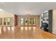 Spacious living room featuring hardwood floors, a cozy fireplace, and lake views at 6033 Mountain Lake Dr, Lakeland, FL 33813