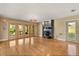 Spacious living room featuring hardwood floors, a cozy fireplace, and natural light at 6033 Mountain Lake Dr, Lakeland, FL 33813