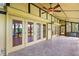 Covered patio with tiled floor, doors to the yard, and ceiling fans for comfort at 6033 Mountain Lake Dr, Lakeland, FL 33813