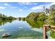 Tranquil lake view with natural foliage and the reflection of clouds on the water at 6033 Mountain Lake Dr, Lakeland, FL 33813