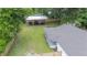 Aerial view of the property highlighting covered parking and a spacious, fenced backyard at 615 N Church Ave, Fort Meade, FL 33841