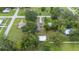 Aerial view of a home with a large yard, mature trees, and a detached garage at 615 N Church Ave, Fort Meade, FL 33841
