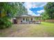 Cozy backyard porch area with comfortable seating overlooking the lawn and perimeter fence at 615 N Church Ave, Fort Meade, FL 33841