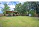 Spacious backyard with covered parking, showcasing an ATV and trampoline for outdoor activities at 615 N Church Ave, Fort Meade, FL 33841