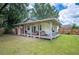 Relaxing backyard porch featuring comfortable seating, overlooking the well-maintained lawn at 615 N Church Ave, Fort Meade, FL 33841