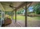 Spacious backyard with a covered patio area, a large shed, and a lush green lawn at 615 N Church Ave, Fort Meade, FL 33841