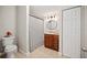 Full bathroom with a toilet, cabinet sink, patterned shower curtain, and closet at 615 N Church Ave, Fort Meade, FL 33841
