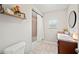 Cozy bathroom features a shower-tub combo, a sink with vanity, and a round mirror at 615 N Church Ave, Fort Meade, FL 33841