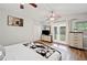 Bright bedroom features a ceiling fan, wood floors, and sliding doors to the backyard at 615 N Church Ave, Fort Meade, FL 33841