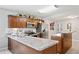 Well-lit kitchen featuring stainless steel appliances, granite countertops, and custom wood cabinetry at 615 N Church Ave, Fort Meade, FL 33841