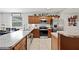Bright kitchen area with stainless steel appliances and wood cabinets offering style and functionality at 615 N Church Ave, Fort Meade, FL 33841